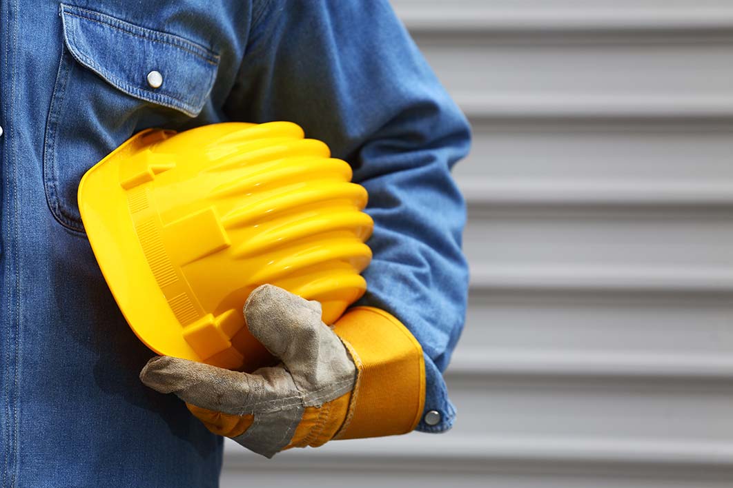 A worker in protective gloves back on the job.
