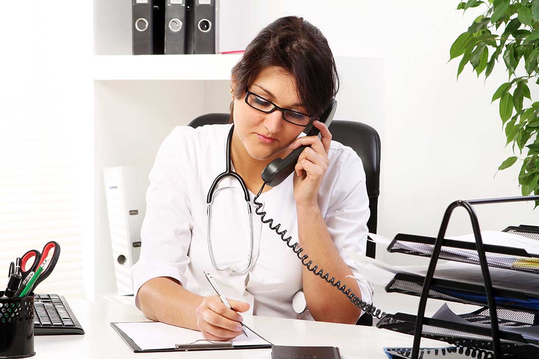 A nurse case manager coordinating care by telephone.