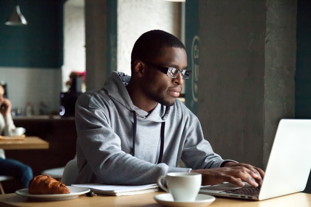 A Ticketholder building a resume on a laptop.